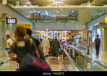 Bangkok, Thailand - February 21, 2017: After airplane landing and arrival at Suvarnabhumi international airport, crowd of passenger walking on escalat Stock Photo