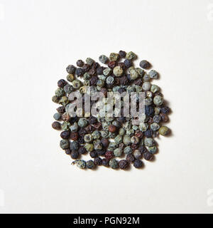 Spices pattern of different kinds of pepper -black, green on a white background . Stock Photo