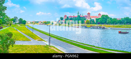 Vistula River boasts wide promenade areas on its both banks for lazy walks overlooking the medieval architecture of Krakow, Poland Stock Photo