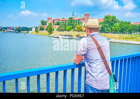 The young tourist overlooking Wawel Castle from Grunwald Bridge, Krakow, Poland Stock Photo