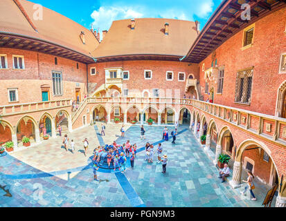 KRAKOW, POLAND - JUNE 11, 2018: Pupils visiting beautiful courtyard of Collegium Maius of Jagiellonian University, that is a very popular landmark of  Stock Photo