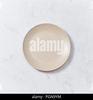 The handmade ceramic dish on a gray marble table. Traditional ceramic handcrafted. Flat lay Stock Photo