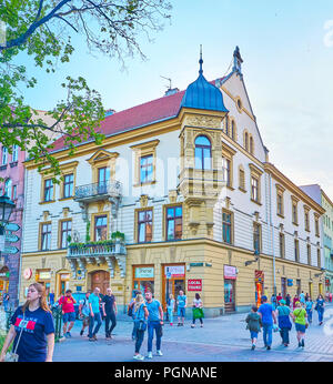 KRAKOW, POLAND - JUNE 11, 2018: The tourists walk in the city center of Krakow at the evening, on June 11 in Krakow Stock Photo