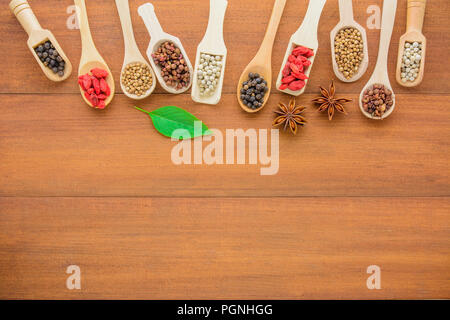 Various kinds of dry herbs (dry grains) in wooden spoon, different kinds of dry herbs in wooden spoon space on wooden table with copy space.Healthy an Stock Photo