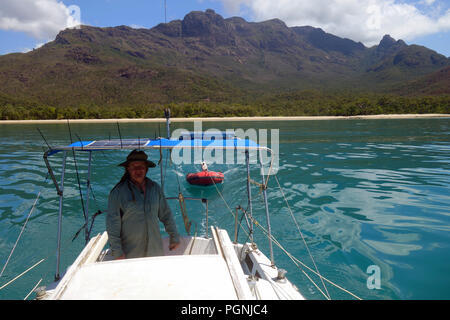 Sailor on yacht, Hinchinbrook island National Park, Queensland, Australia. No MR or PR Stock Photo