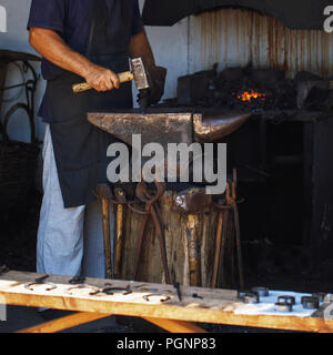 Man at work in the smithy working with metal Stock Photo