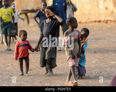 DAGOMBA VILLAGE, GHANA - JAN 14, 2017: Unidentified Dagomban children walk in the local village. Dagombas are ethnic group of Northern Ghana Stock Photo