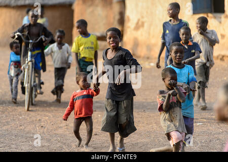 DAGOMBA VILLAGE, GHANA - JAN 14, 2017: Unidentified Dagomban children walk in the local village. Dagombas are ethnic group of Northern Ghana Stock Photo