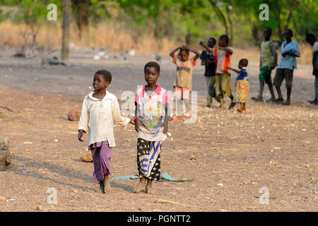 DAGOMBA VILLAGE, GHANA - JAN 14, 2017: Unidentified Dagomban children walk in the local village. Dagombas are ethnic group of Northern Ghana Stock Photo