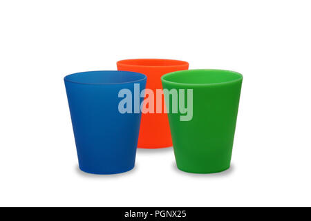 Multicolor plastic glasses, cups blue orange green on isolated white background Stock Photo