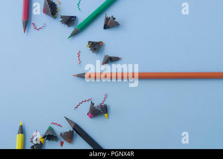 Colorful pencils organized in half round isolated on a light blue pastel background. Space for text, flat lay. Stock Photo