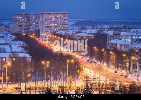 Kemerovo, Russia - January 30, 2018 - aerial winter view of prefabricated multistorey residential buildings at nights; illuminated streets with cars Stock Photo