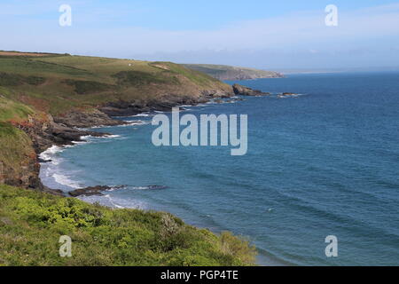 coast of Cornwall with clear blue sea in summer from the south west coastal path Stock Photo