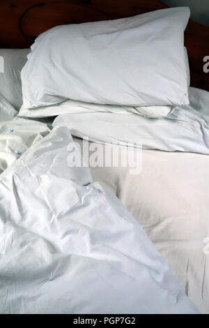 Egyptian cotton bedding on comfortable bed in a cottage guest bedroom Stock Photo