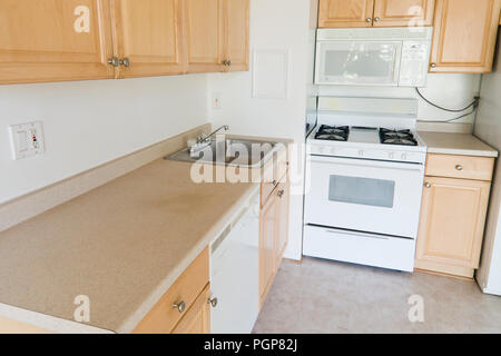 Small modular kitchen in a condominium unit (empty kitchen) - USA Stock Photo