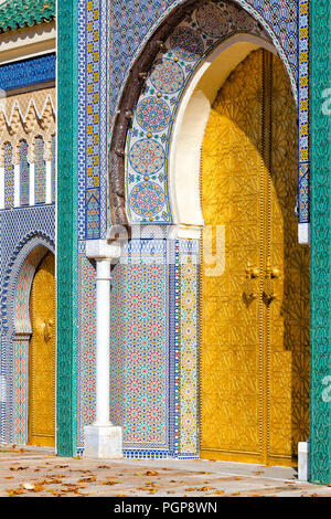 Morocco Royal Palace brass doors with intricate mosaic tiling and architectural detail. Location: Fes Stock Photo