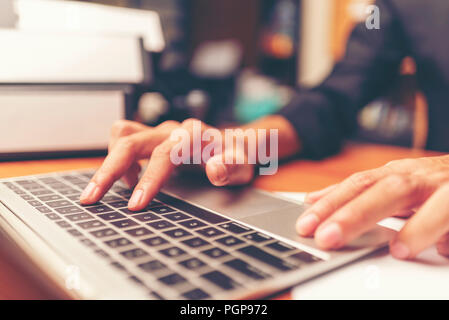 Cropped shot of a man's hands using a laptop at home, rear view of business man hands busy using laptop at office desk, young male student typing on c Stock Photo