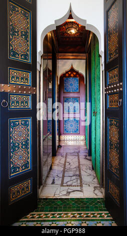 Moroccan beautiful painted doors and marble tiled hallway with mosaic flooring. Stock Photo