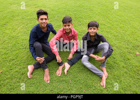 Portrait of Indian family relaxing together at the park Stock Photo