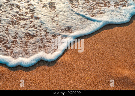 Soft wave of ocean on sandy beach. Background. Stock Photo