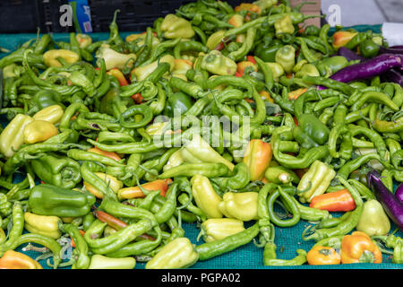 Pile of peppers of various kinds, mainly green; food market, San Francisco, California Stock Photo