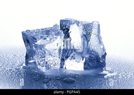 two ice cubes with water drops on white wet background Stock Photo