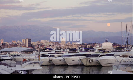 Full moon rising over the mountains and harbour in Split, Croati Stock Photo