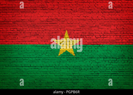 National flag of Burkino Faso on a brick background Stock Photo