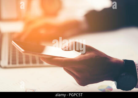 businessman using tablet smartphone for working in the office Stock Photo