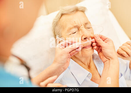 Senior as a patient with nasal cannula during an oxygen therapy in the hospital Stock Photo