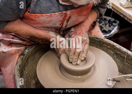 old man spinning potters wheel making clay plate,pilling,lancashire,england,uk Stock Photo