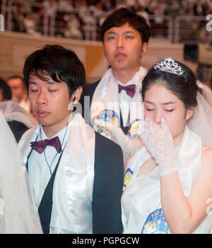 Seoul, South Korea. 27th Aug 2018. Mass wedding ceremony of the Unification Church, Aug 27, 2018 : Couples from Japan pray during a mass wedding ceremony of the Unification Church at the CheongShim Peace World Center in Gapyeong, about 60 km (37 miles) northeast of Seoul, South Korea. Four thousand newlywed couples from around the world participated in the mass wedding on Monday, which was organized by Hak Ja Han Moon, wife of the late Reverend Sun Myung Moon. Credit: Aflo Co. Ltd./Alamy Live News Stock Photo
