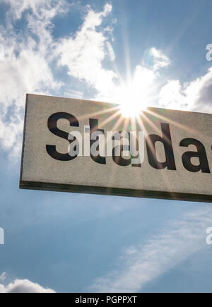 Bad Vilbel, Germany. 28th Aug, 2018. The sun shines behind the street sign of 'Stadastrasse' at the headquarters of the drug manufacturer Stada. Credit: Frank Rumpenhorst/dpa/Alamy Live News Stock Photo