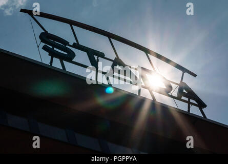 Bad Vilbel, Germany. 28th Aug, 2018. The sun shines through the company logo of Stada on one of the buildings at the company headquarters of the pharmaceutical manufacturer. Credit: Frank Rumpenhorst/dpa/Alamy Live News Stock Photo