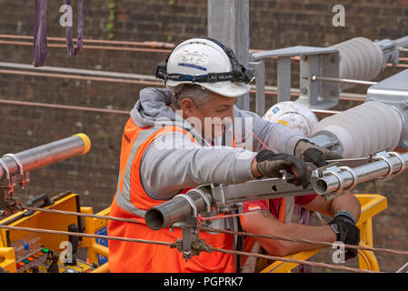 Newbury, Berkshire, UK. 28th August 2018. Newbury Station, Berkshire UK. Engineers working on the electrification  of the railway line at Newbury earlier today. The Great Western Railway region is closed in ths area until August 31st. Credit: Peter Titmuss/Alamy Live News Stock Photo