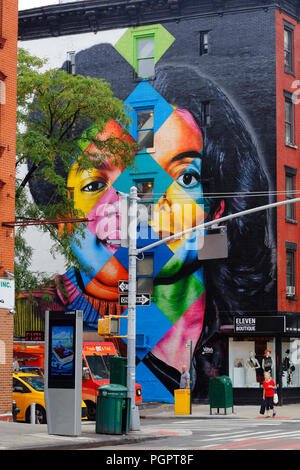 New York, NY, USA. 28th August, 2018.   Local residents of Manhattan's East Village walk past a recently painted, colorful image of Michael Jackson by Brazilian muralist Eduardo Kobra to celebrate the King of Pop's 60th birthday. Stock Photo