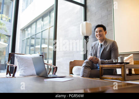 Confident businessman drinking tea Stock Photo