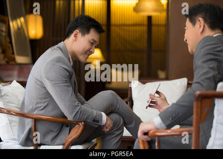 Cheerful businessmen using smart phone Stock Photo