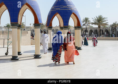 TOUBA, SENEGAL - APR 26, 2017: Unidentified Senegalese people in long traditional clothes walk in the Great Mosque of Touba, the home of the Mouride B Stock Photo