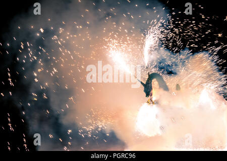 Correfoc performance by the dragon and fire. Folkrore an tradition in Catalonia, Spain Stock Photo