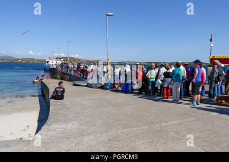 Queue of tourists and visitors leaving Iona on the Calmac ferry  to Fionnphort, Isle of Mull Stock Photo