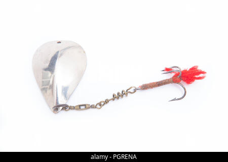 An old metal fishing lure designed for catching predatory fish equipped with a treble hook. From a collection of vintage and modern fishing tackle. No Stock Photo