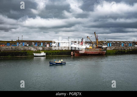 Small fishing boat returning to harbour, in Newlyn. In Newlyn, Cornwall, England. On 20th June 2018. Stock Photo