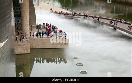 BILBAO, SPAIN - JULY 25, 2018: Transitory Fog Sculpture by Fujiko Nakaya is on display outside of Guggenheim Museum Bilbao in  Basque Country capital  Stock Photo