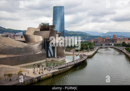 BILBAO, SPAIN - JULY 25, 2018: Tourists flock to Guggenheim Museum Bilbao, one of the most popular tourist attractions in  Basque Country capital on J Stock Photo