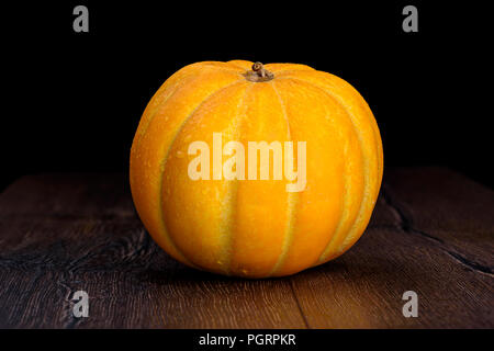 Melon with water droplets on a wooden background Stock Photo