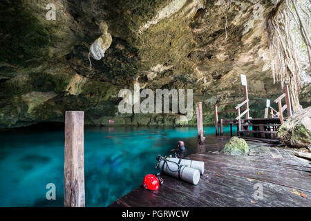 One of the cavern entrances to Dos Ojos cenote near Tulum, Mexico with diver blurred out . Stock Photo