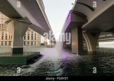 The mechanical waterfall, where the Dubai Water Canal meets Sheikh Zayed Road, during the day, Dubai, UAE Stock Photo