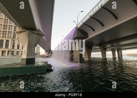 The mechanical waterfall, where the Dubai Water Canal meets Sheikh Zayed Road, during the day, Dubai, UAE Stock Photo