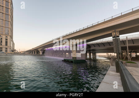 The mechanical waterfall, where the Dubai Water Canal meets Sheikh Zayed Road, during the day, Dubai, UAE Stock Photo